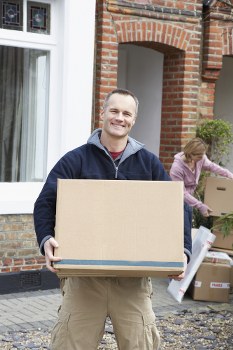 Man and van removal team loading furniture in Ealing