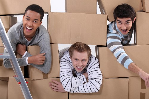 Packed boxes and furniture ready for a moving truck in Ealing