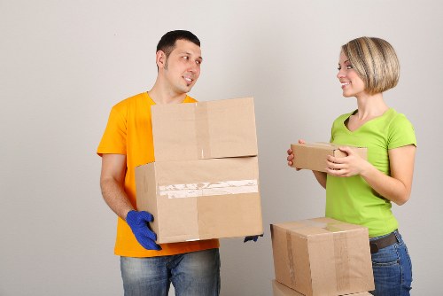 Packed moving boxes and furniture ready for transport in Ealing